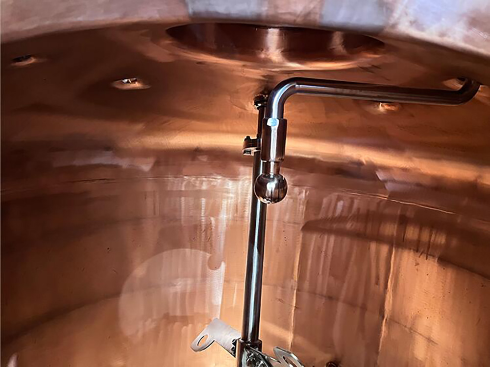 What is the difference between the copper materials CU1220 and CU1100 for distillation equipment?